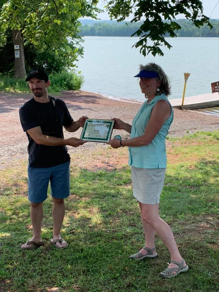 Ryan Beltz, Executive Director of the Perkiomen Watershed Conservancy is presented with Pennyslvania Parks and Forests Foundation COVID-19 Champion Award for Stewardship by PPFF President Marci Mowery.