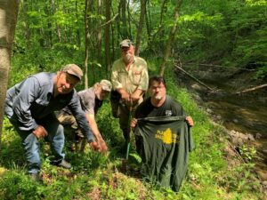 2025 10 Reparian Buffer Blog Picture4 Group of club members pointing out a tree they planted. Jim Weaver is the one holding the dibble bar