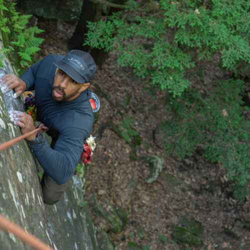 shoffner climbs a rock